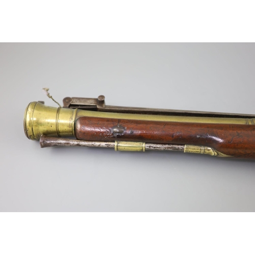 25 - A late 18th century brass barrelled flintlock blunderbuss, by Jones, with chequered mahogany stock, ... 