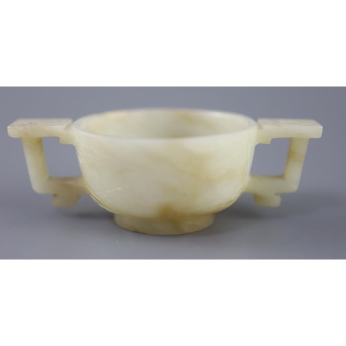 254 - A Chinese pale celadon and russet jade cup, 17th/18th century, carved in low relief to each side wit... 