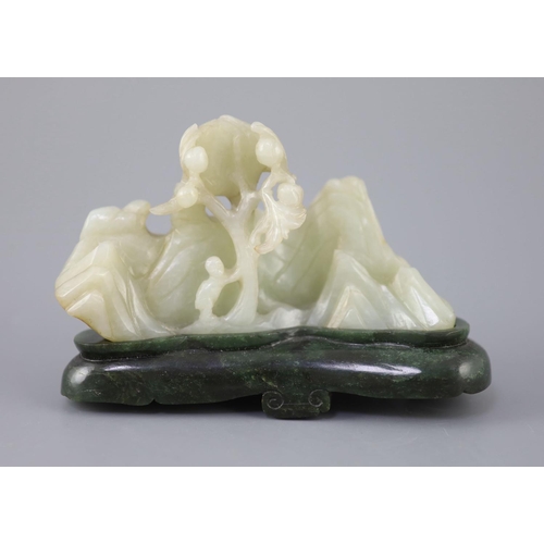 255 - A Chinese pale celadon jade boulder carving, Qing dynasty, carved in high relief and openwork with a... 