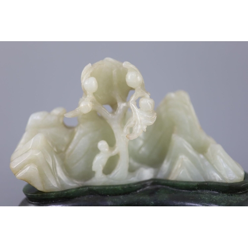 255 - A Chinese pale celadon jade boulder carving, Qing dynasty, carved in high relief and openwork with a... 