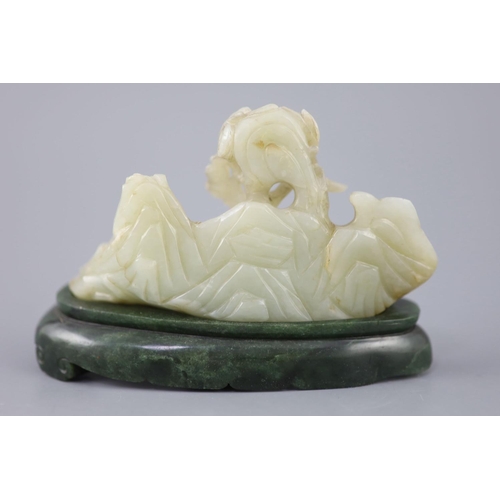 255 - A Chinese pale celadon jade boulder carving, Qing dynasty, carved in high relief and openwork with a... 