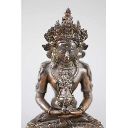 265 - A Tibetan silver and gold inlaid copper alloy figure of Amitayus/Amitabha, c.15th century, seated in... 