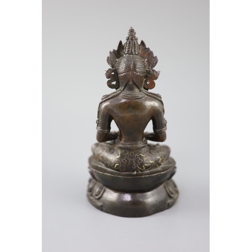 265 - A Tibetan silver and gold inlaid copper alloy figure of Amitayus/Amitabha, c.15th century, seated in... 