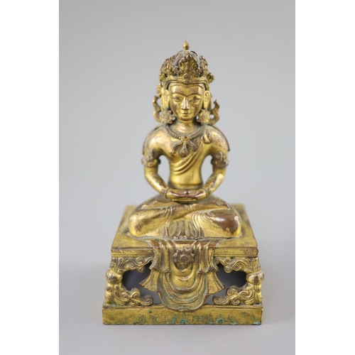 272 - A Chinese gilt bronze seated figure of Amitayus, Qianlong period, dated 1770, the crowned figure hol... 