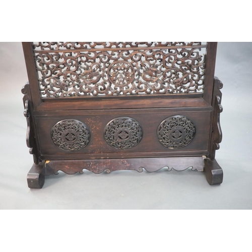 284 - A large Chinese hardwood table screen, c.1910, the inset screen profusely carved and pierced with sc... 