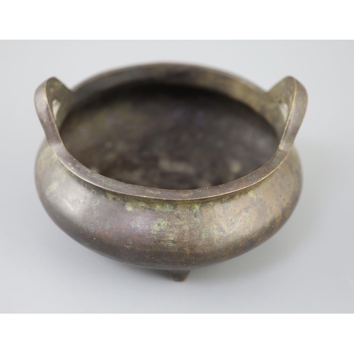 287 - A Chinese bronze tripod censer, Xuande mark but 19th century, with a pair of high-looped handles, on... 