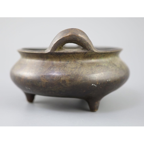 287 - A Chinese bronze tripod censer, Xuande mark but 19th century, with a pair of high-looped handles, on... 