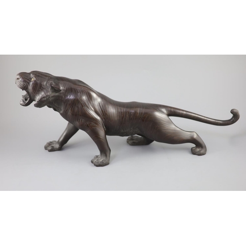 293 - A Japanese bronze figure of a tiger, naturalistically modelled, standing roaring, Meiji period, sign... 