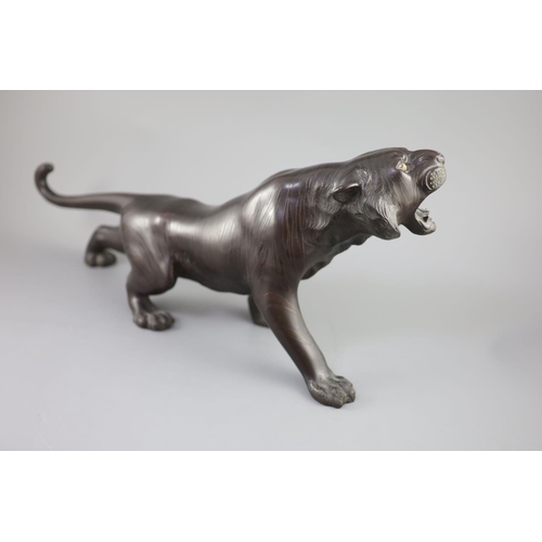 293 - A Japanese bronze figure of a tiger, naturalistically modelled, standing roaring, Meiji period, sign... 