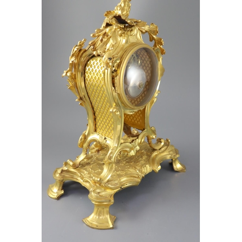 295 - A mid 18th century French ormolu mantel clock, with ornate pierced foliate scroll case and enamelled... 