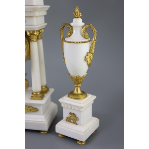 297 - A Louis XVI style ormolu mounted white marble clock garniture, with Portico clock flanked by a pair ... 