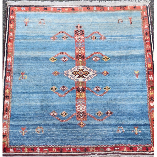 306 - An Iranian Qushqa'i Gabbeh blue ground carpet, with central geometric motif and single row border, 6... 