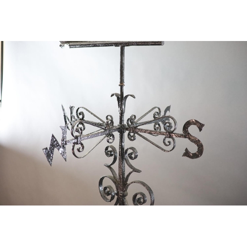 308 - A large Victorian black painted wrought iron weather vane, surmounted with a running hound, with ind... 