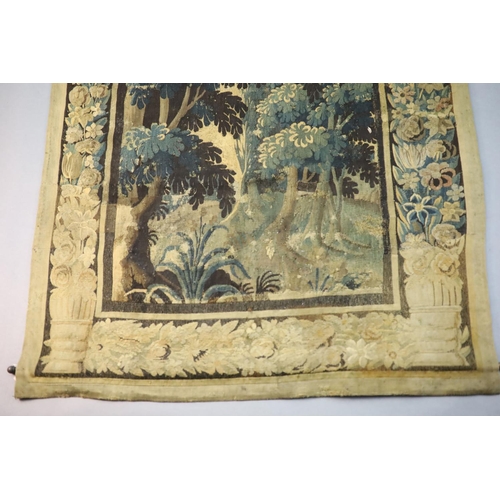 311 - A 17th century Flemish verdure tapestry wall hanging, with central panel of trees withing flower and... 