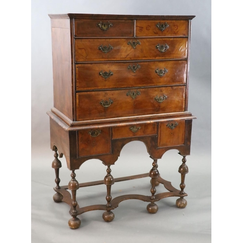 314 - An early 18th century walnut chest on stand, with veneered top, two short and three graduated long d... 