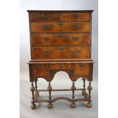 314 - An early 18th century walnut chest on stand, with veneered top, two short and three graduated long d... 