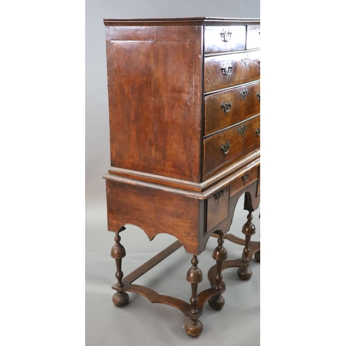 314 - An early 18th century walnut chest on stand, with veneered top, two short and three graduated long d... 