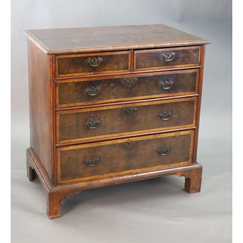 315 - An early 18th century oyster veneered chest, of two short and three graduated long drawers, on later... 