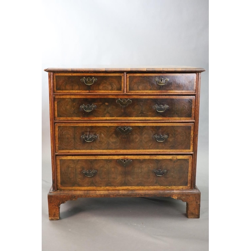 315 - An early 18th century oyster veneered chest, of two short and three graduated long drawers, on later... 