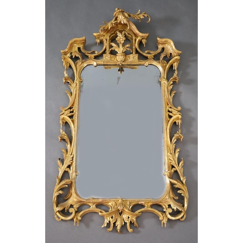 322 - A George III Chippendale style carved giltwood wall mirror, with stylised arched crest centred with ... 