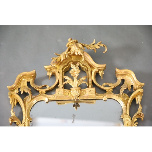 322 - A George III Chippendale style carved giltwood wall mirror, with stylised arched crest centred with ... 