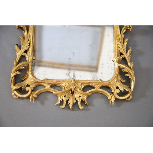 322 - A George III Chippendale style carved giltwood wall mirror, with stylised arched crest centred with ... 