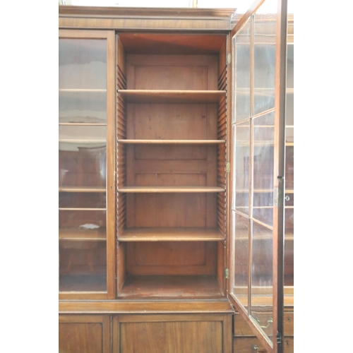 324 - A George III mahogany breakfront library bookcase, with moulded cornice and four astragal glazed doo... 