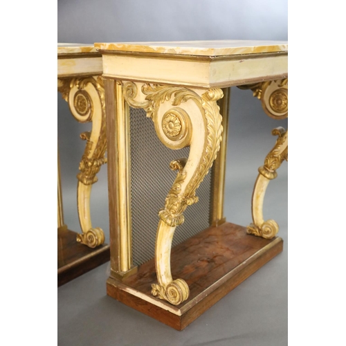 328 - A pair of William IV parcel gilt cream painted and rosewood console tables, with later marble tops a... 