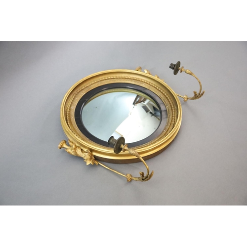 330 - A William IV giltwood and gesso convex girandole, with ropetwist frame, ebonised slip and foliate sc... 