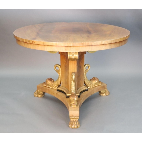 335 - A Regency style mahogany centre table, with circular top, on concave sided triangular stem, mounted ... 