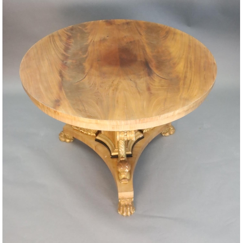 335 - A Regency style mahogany centre table, with circular top, on concave sided triangular stem, mounted ... 