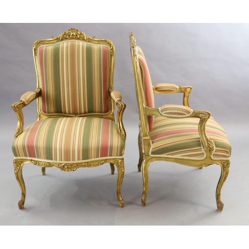 341 - A pair of French gilt beech fauteuils, with moulded foliate scroll carved frames and cabriole legs, ... 