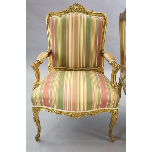 341 - A pair of French gilt beech fauteuils, with moulded foliate scroll carved frames and cabriole legs, ... 