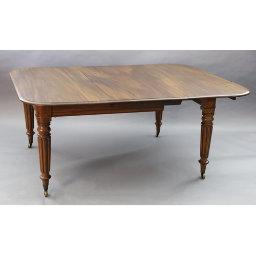 342 - A Victorian mahogany extending dining table, with rounded rectangular top and three spare leaves, on... 