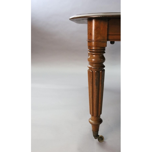 342 - A Victorian mahogany extending dining table, with rounded rectangular top and three spare leaves, on... 