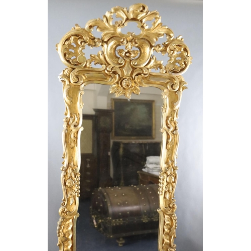 344 - A late 19th century French carved giltwood wall mirror, of generous proportions, decorated with pier... 