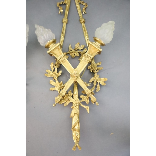 345 - A pair of early 20th century Louis XVI style ormolu wall lights, with ribbon and oak branch backs, t... 