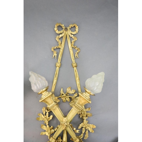 345 - A pair of early 20th century Louis XVI style ormolu wall lights, with ribbon and oak branch backs, t... 