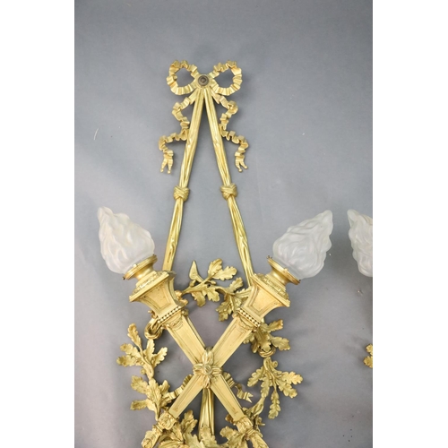 345 - A pair of early 20th century Louis XVI style ormolu wall lights, with ribbon and oak branch backs, t... 