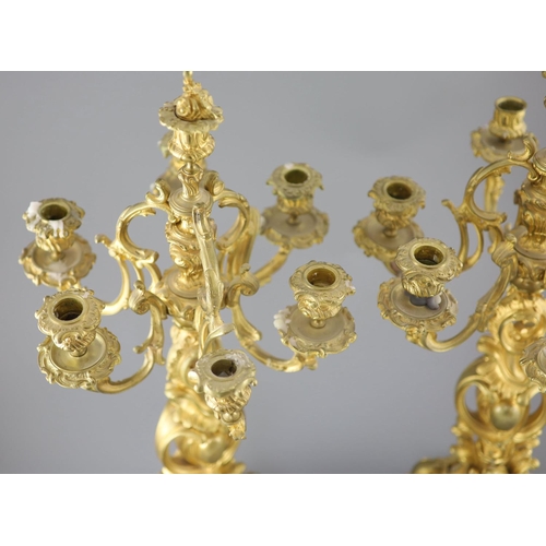 35 - A pair of late 19th century French Louis XV style ormolu seven light candelabra, with foliate scroll... 