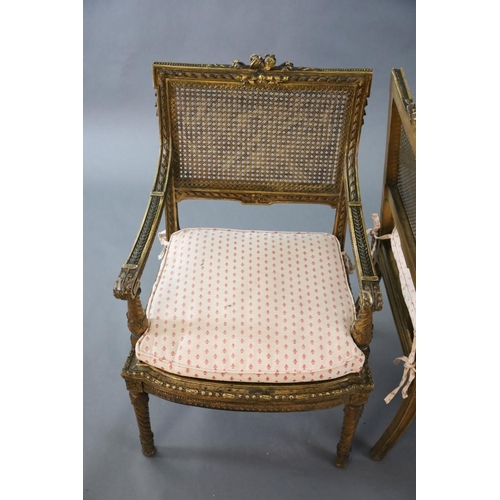 356 - A pair of Louis XVI style walnut giltwood fauteuils, with flower and ribbon carved frames, caned bac... 