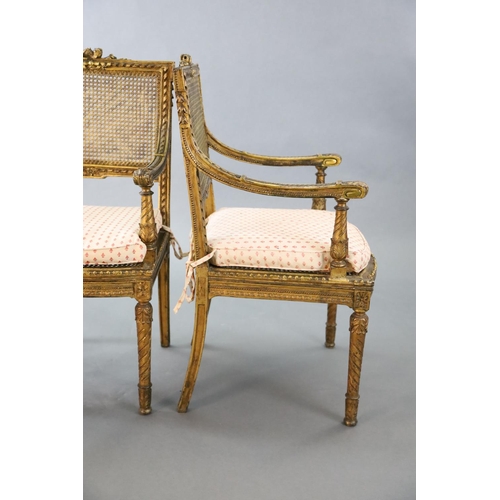 356 - A pair of Louis XVI style walnut giltwood fauteuils, with flower and ribbon carved frames, caned bac... 