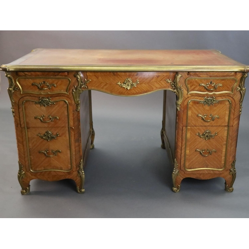 357 - An early 20th century Louis XVI style ormolu mounted satinwood and rosewood kneehole desk, with pale... 