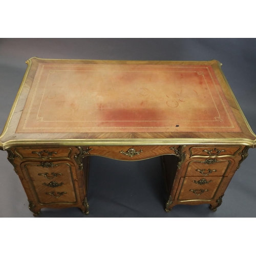 357 - An early 20th century Louis XVI style ormolu mounted satinwood and rosewood kneehole desk, with pale... 