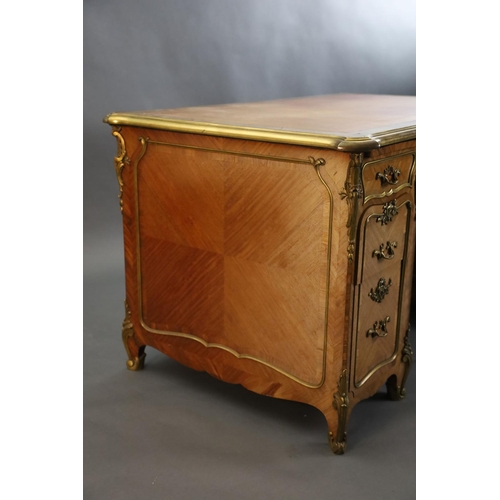 357 - An early 20th century Louis XVI style ormolu mounted satinwood and rosewood kneehole desk, with pale... 