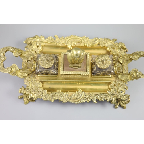 36 - A Victorian ormolu ink stand, the central wafer box applied with a bust of a Shakespeare and flanked... 