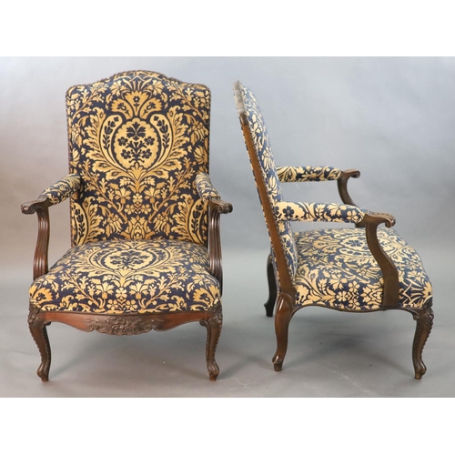 360 - A pair of Louis XVI style mahogany fauteuils, with gadroon and floral scroll carved frames, later up... 