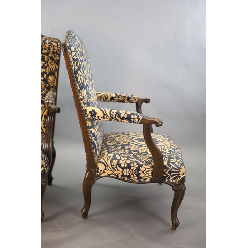 360 - A pair of Louis XVI style mahogany fauteuils, with gadroon and floral scroll carved frames, later up... 