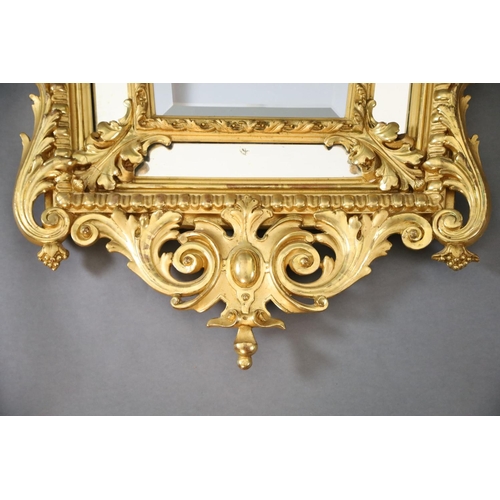 364 - A Louis XIV style carved giltwood wall mirror, with putto mask, fruit and foliate scroll crest, tape... 