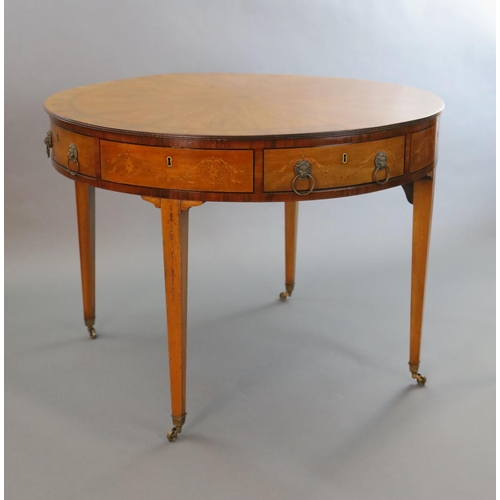 369 - An Edwardian marquetry inlaid satinwood drum top library table, with starburst top inlaid with styli... 